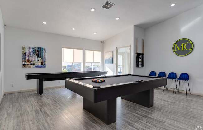 A pool table in a room with a logo on the wall.