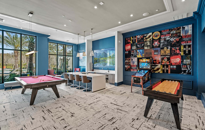 a game room with pool tables and a wall covered in posters at Altis Grand Suncoast, Florida, 34638