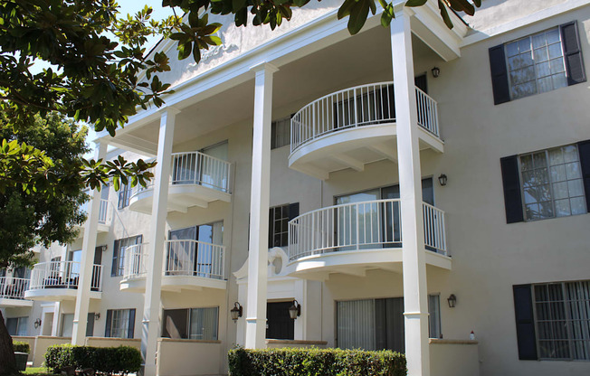 A white apartment building with balconies and windows.