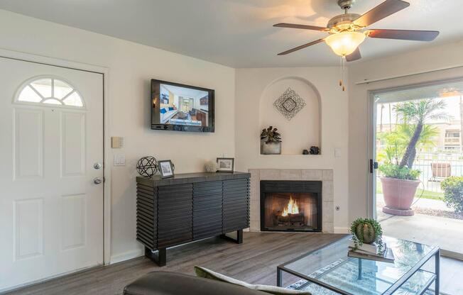 a living room filled with furniture and vase of flowers on a table