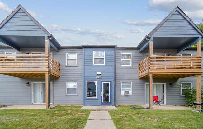 A two-story house with a balcony on each floor.