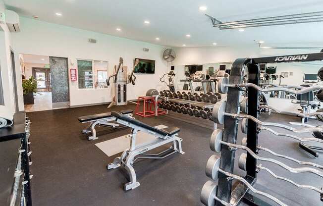 A gym with a variety of equipment including a squat rack and a bench press. at Notch 8, Tacoma, WA, 98444