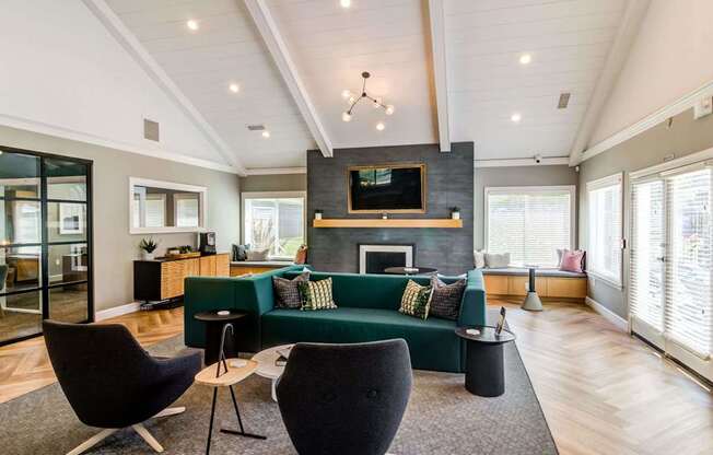 a living room with a green couch and a fireplace