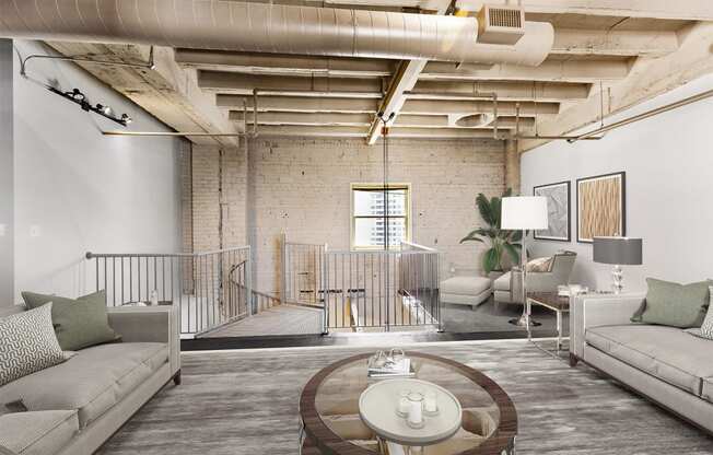 a living room with couches and a coffee table in a loft