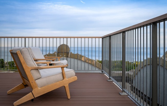 a lounge chair on a balcony overlooking the ocean at the Belden Stratford in Chicago, IL 60614