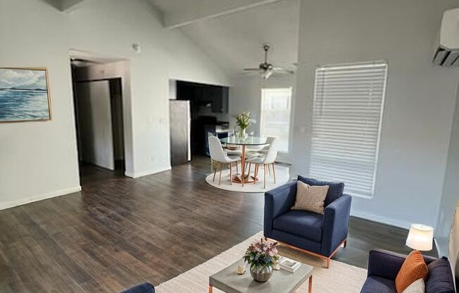 A living room with a blue couch and a coffee table.