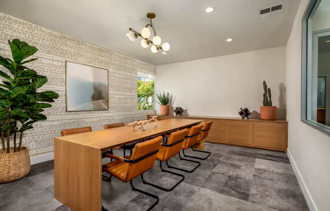 A conference room with a long table and chairs.