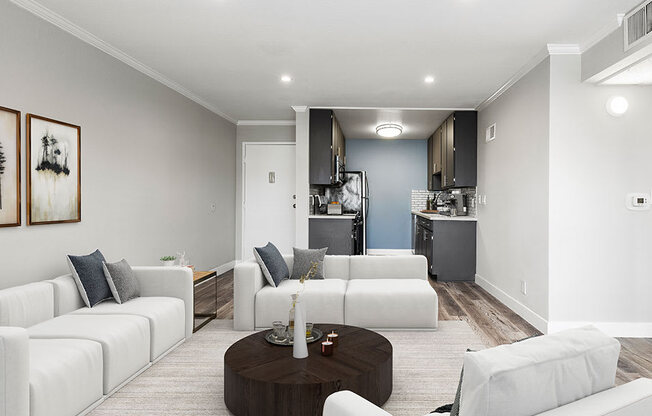 Hardwood floored living room with view of kitchen.