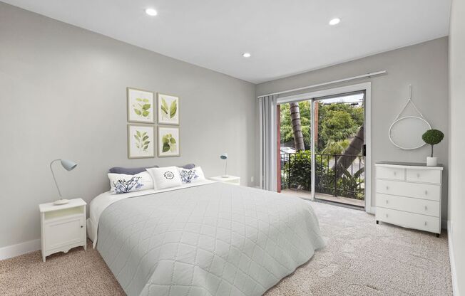 a white bedroom with a bed and a sliding glass door