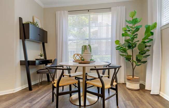 a dining room with a table and chairs and a window at Madison on the Meadow, Texas