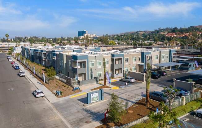 a row of apartment buildings with cars parked in front of them at Loma Villas Apartments, San Bernardino, 92408