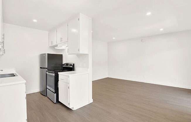 A kitchen with white appliances and cabinets.