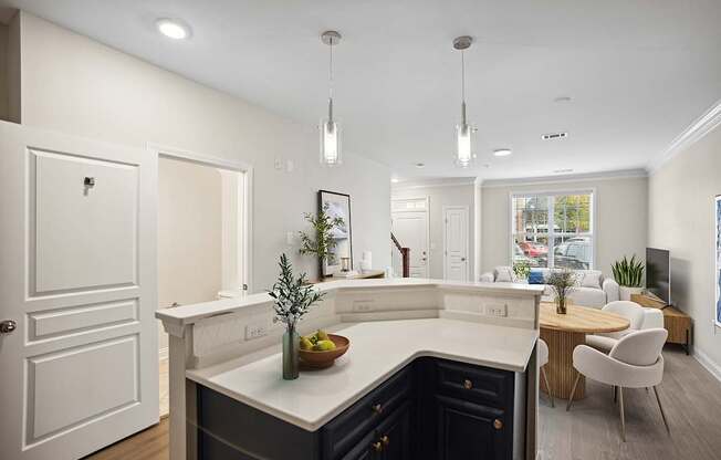 A modern kitchen with a dark blue counter and white cabinets.
