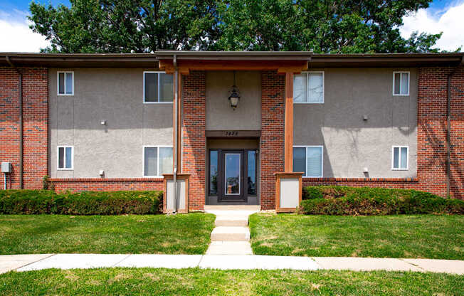 A brick building with a front door and windows.