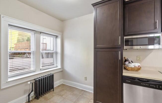 a kitchen with a dishwasher and a sink and a window