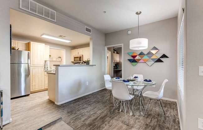 A modern kitchen with a dining table set for four.