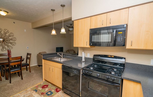 Kitchen With Cabinetry And Black Appliances at Lynbrook Apartment Homes and Townhomes, Nebraska, 68022