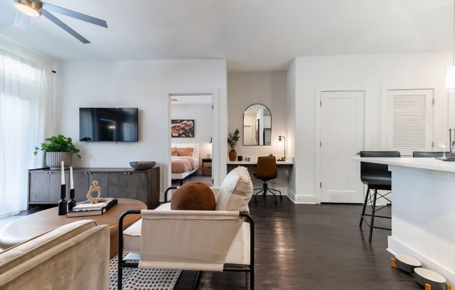 a living room with a couch and a chair and a television