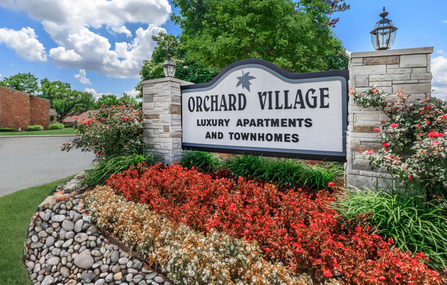 a sign that reads orchard village luxury apartments and townhomes