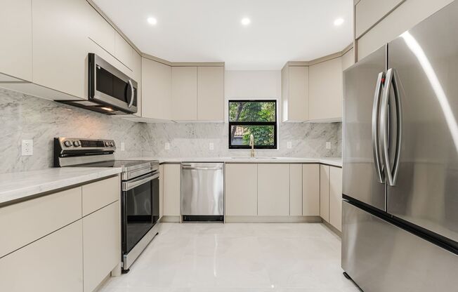 Beautifully renovated 4 bed 2 bath home with a large backyard and parking.