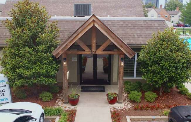 the front entrance to the leasing office of a house with a swimming pool