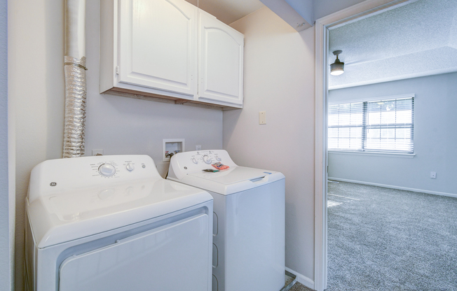 Side by side washer and dryer in townhome platinum interior at The Arbor in Blue Springs, Missouri