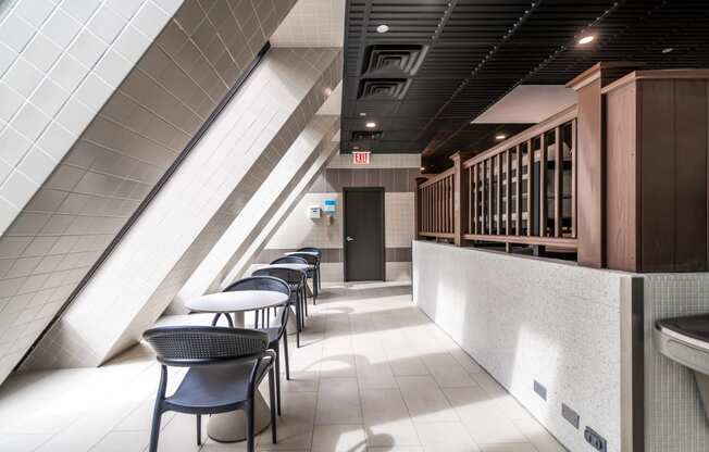 a row of tables and chairs in a corridor