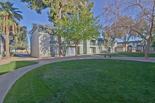 a park with a green lawn and a building in the background at Missouri Crossing, Phoenix, AZ, 85015