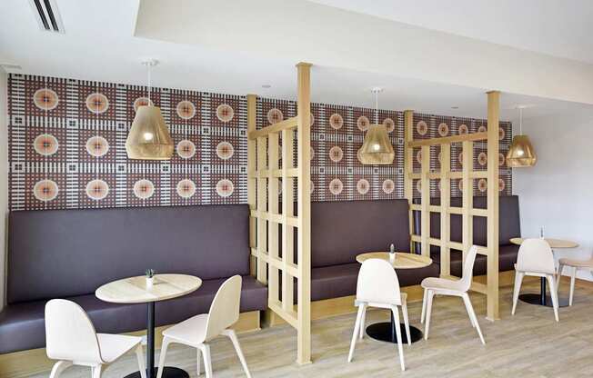 A restaurant with a patterned wallpaper and wooden partition.