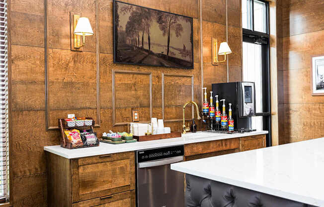 A kitchen with a white counter top and a black dishwasher.