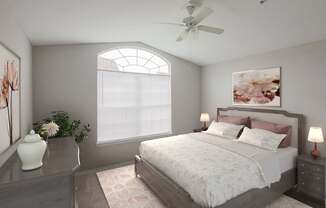 A bedroom with a large bed, a ceiling fan, and a painting of flowers on the wall.