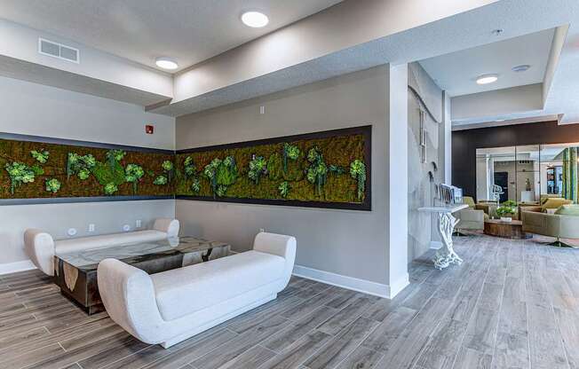A living room with a large painting of green plants on the wall.at Tiffany Flats, Columbus, Ohio