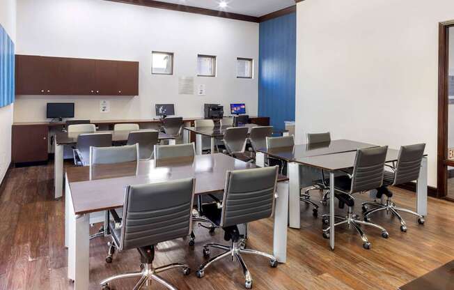 A conference room with a long table and chairs.