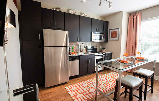 Fitted Kitchen With Island Dining at Link Apartments® Brookstown, Winston Salem, NC