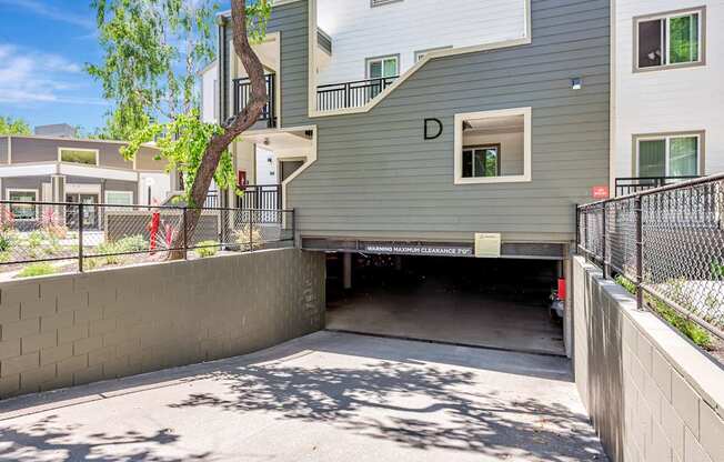A modern two-story building with a garage under the letter D.