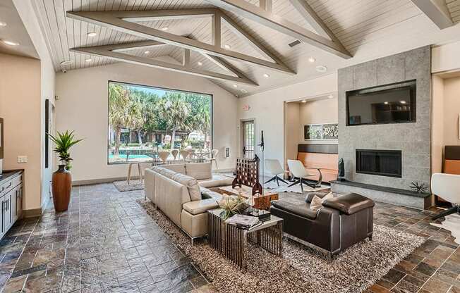 A living room with a stone floor and a large window.