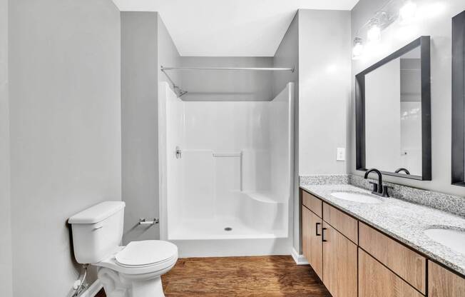 a bathroom with a toilet and a sink and a shower