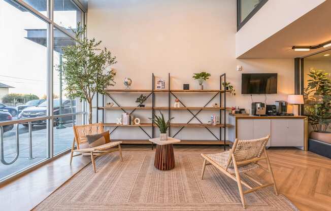 A living room with a brown rug and wooden furniture.