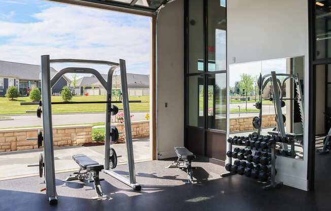 a gym with weights and a window in a building