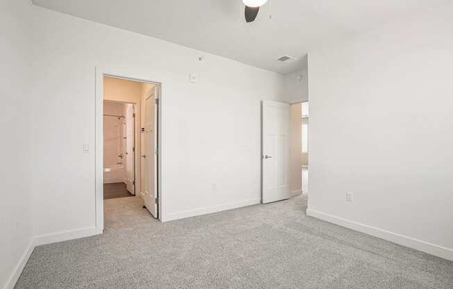 a bedroom with white walls and carpet at Meadowbrooke Apartment Homes, Grand Rapids, MI