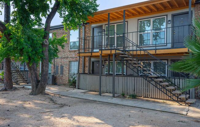 a house with a fence in front of a building