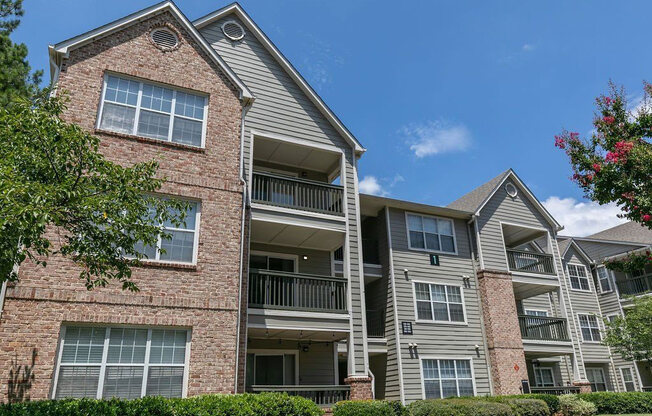 an apartment building with brick and stone walls and balconies at Gwinnett Pointe, Norcross