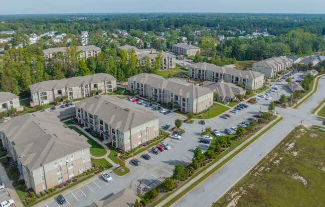 an aerial view of a group of houses in a parking lot