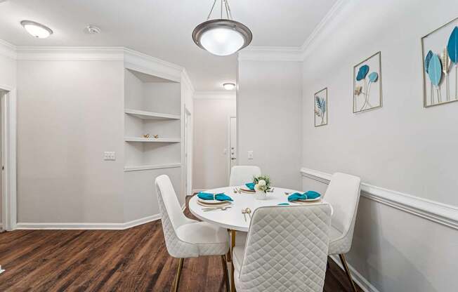 A dining room with a table set for two.