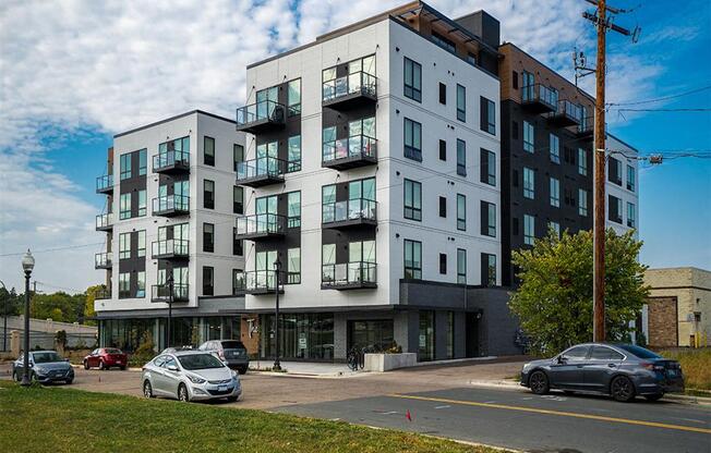 a new apartment building on a city street with cars