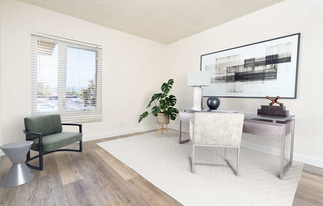 a living room with a white rug and a desk with a chair