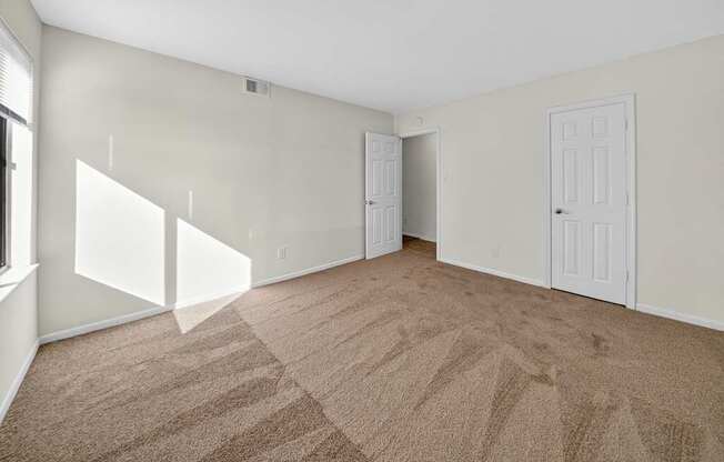 A room with carpeted floor and white walls.