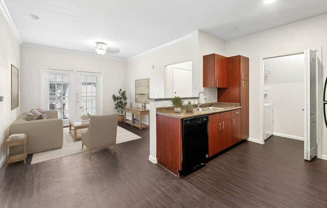 A modern kitchen with wooden cabinets and a black dishwasher.