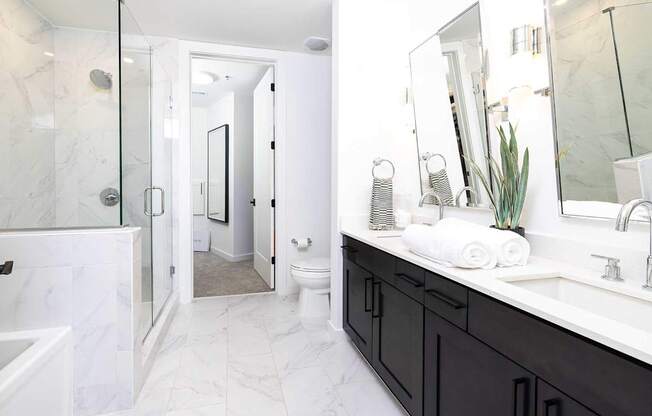 A bathroom with a white toilet and a white sink.