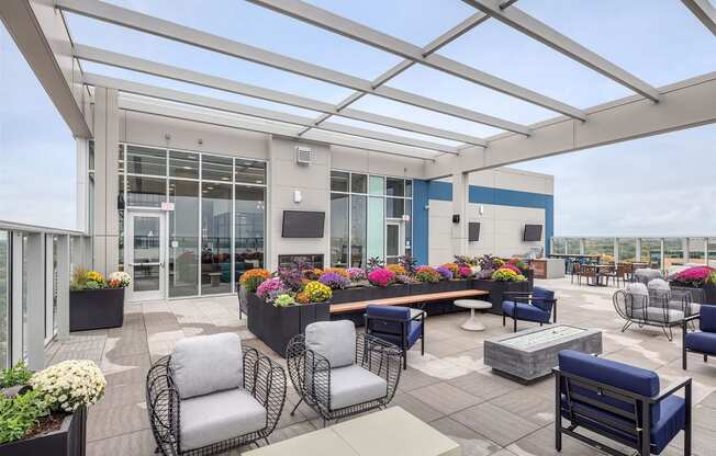 a terrace with chairs and tables and a large glass roof